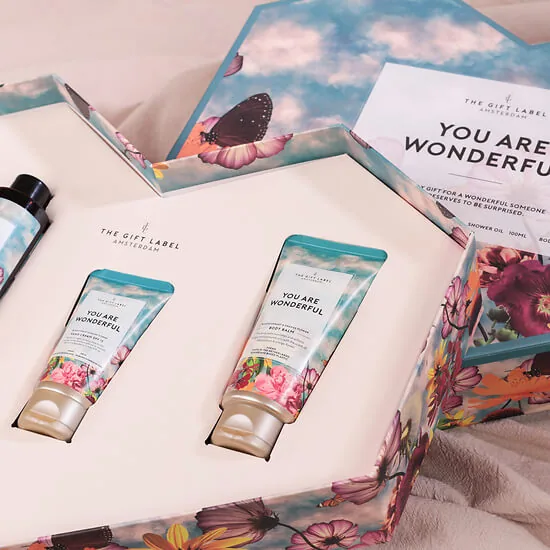 Open wellness box showing the shower gel, lotion, hand cream and body balm